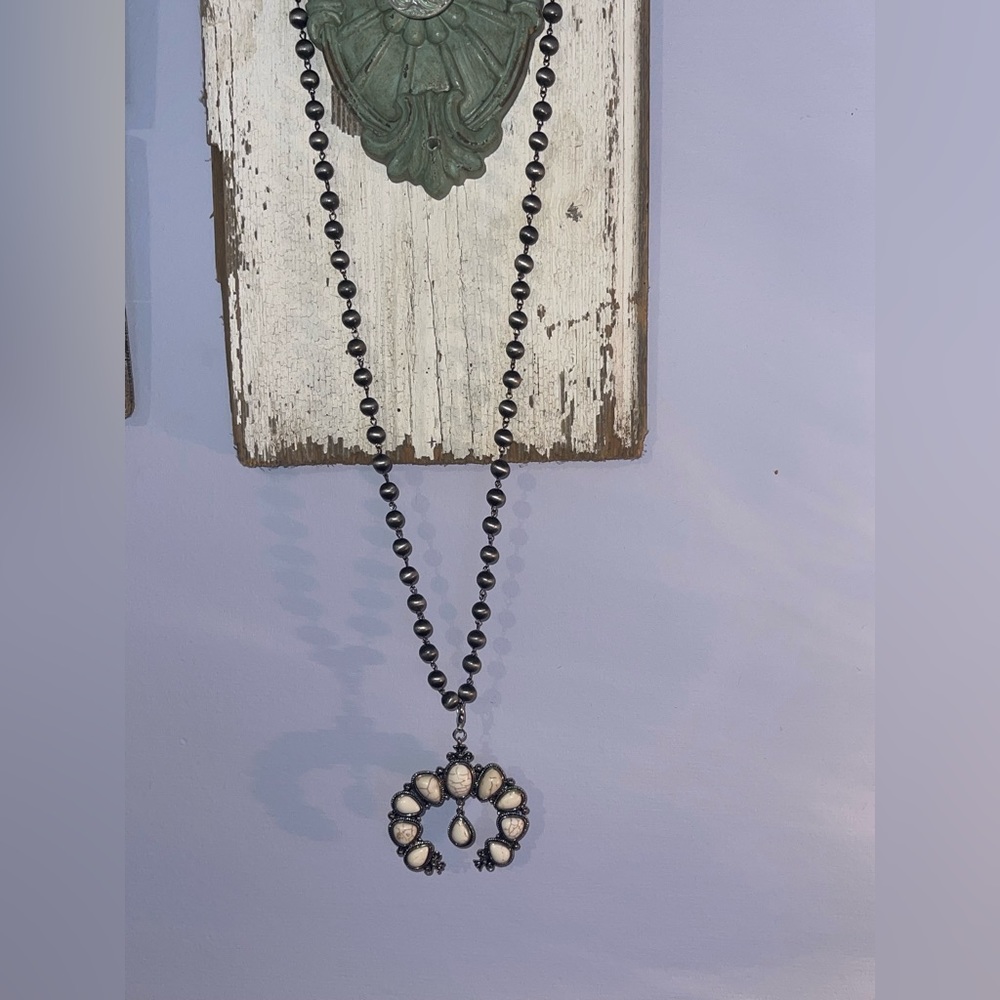 Long grey beaded cream colored squash blossom necklace